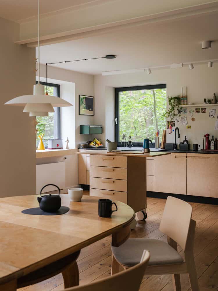 Open-plan kitchen and dining area of Skubianka House by SZCZ Jakub Szczesny in Skubianka