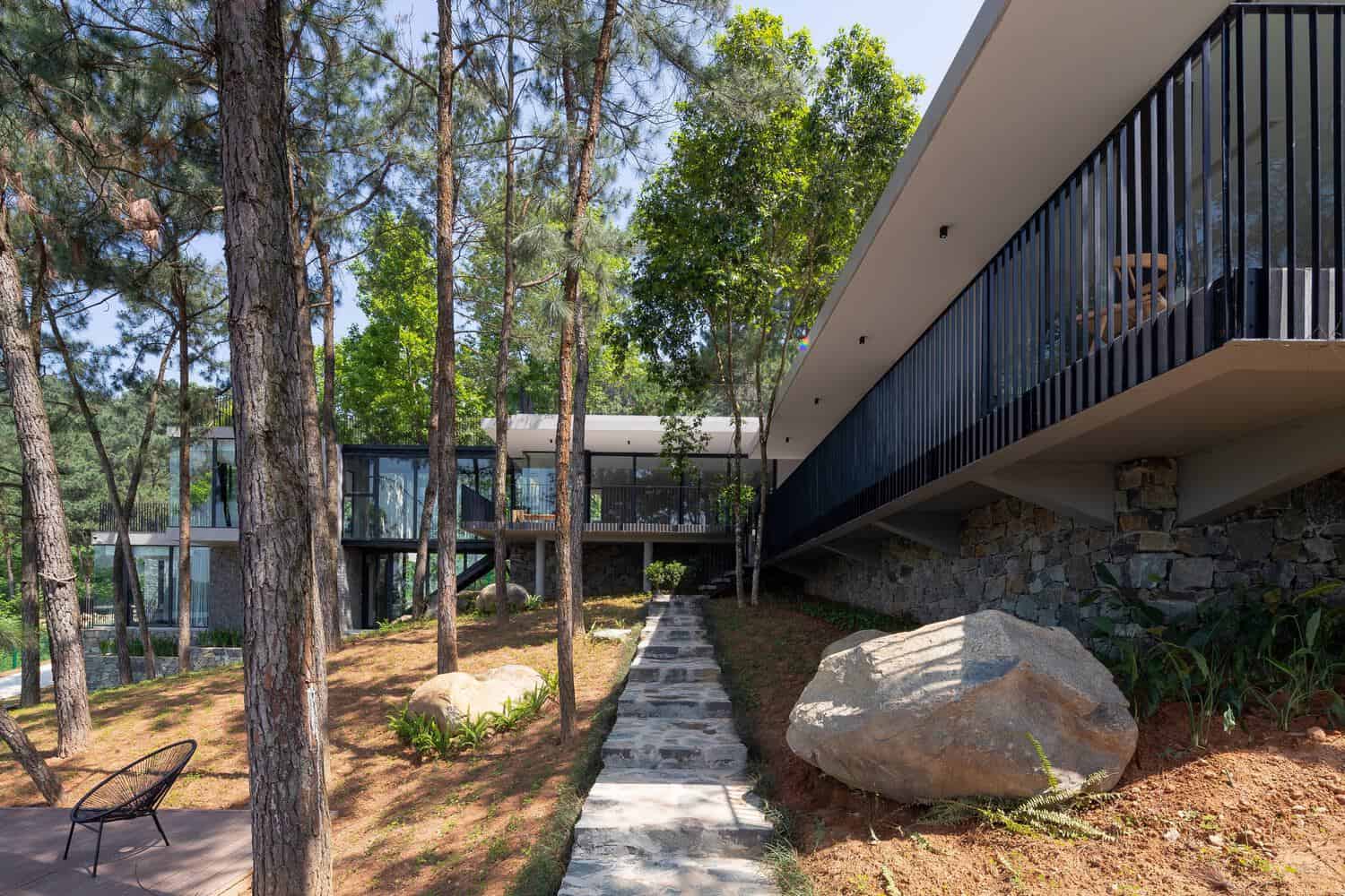 Tam Dao Retreat House by Idee architects central elevated walkway bridging volumes in Tam Dao, Vietnam