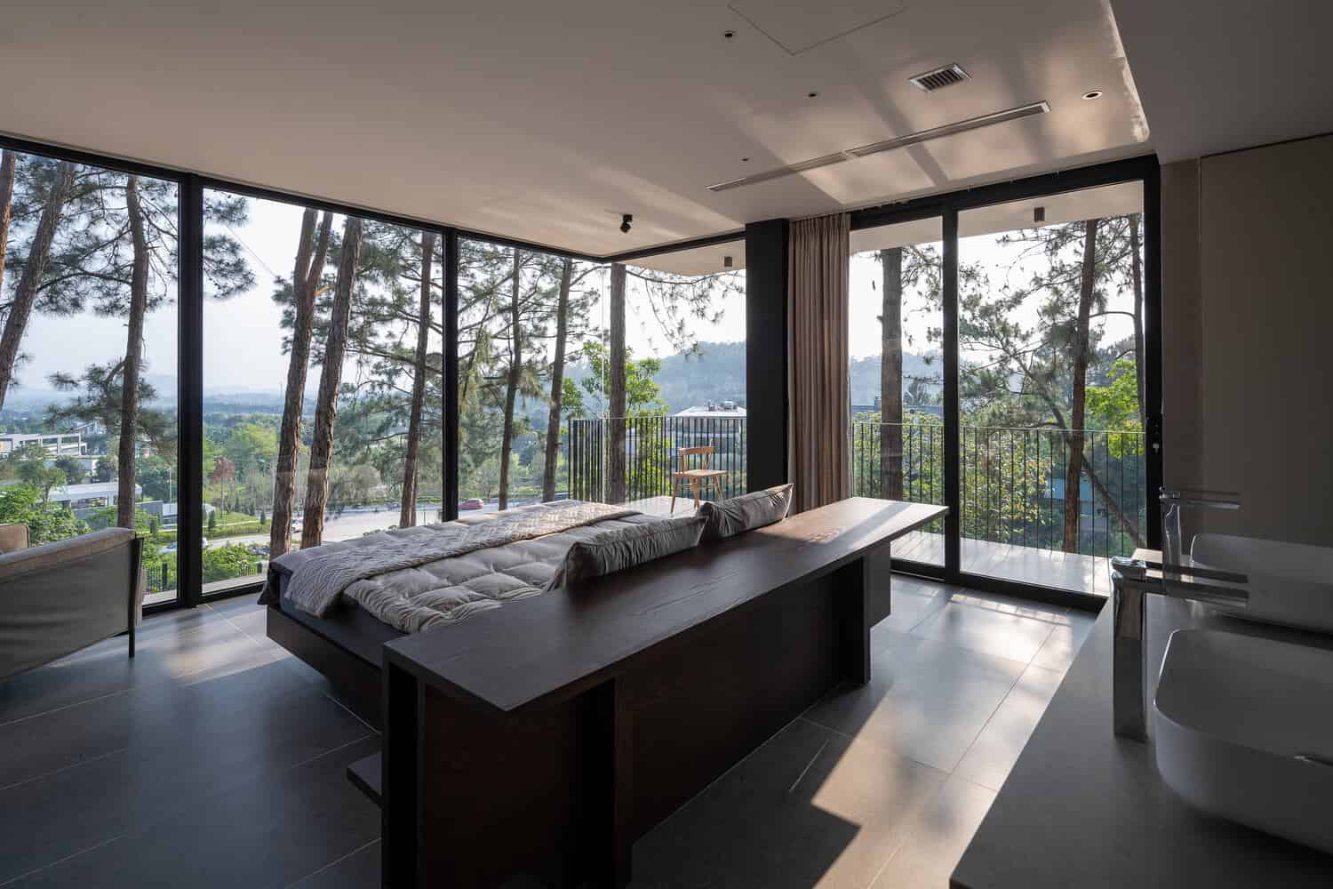Tam Dao Retreat House by Idee architects corner bedroom with panoramic forest and valley views in Tam Dao, Vietnam