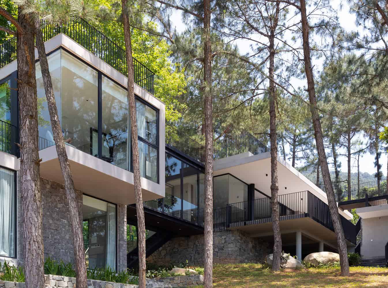 Tam Dao Retreat House by Idee architects glass volumes stepping down forest slope in Tam Dao, Vietnam
