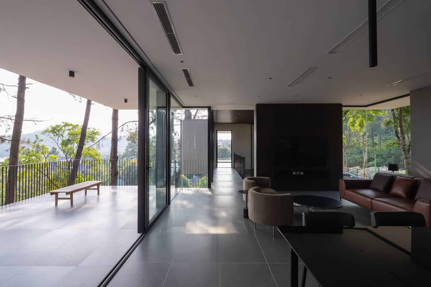 Tam Dao Retreat House by Idee architects open living room connected to large terrace in Tam Dao, Vietnam
