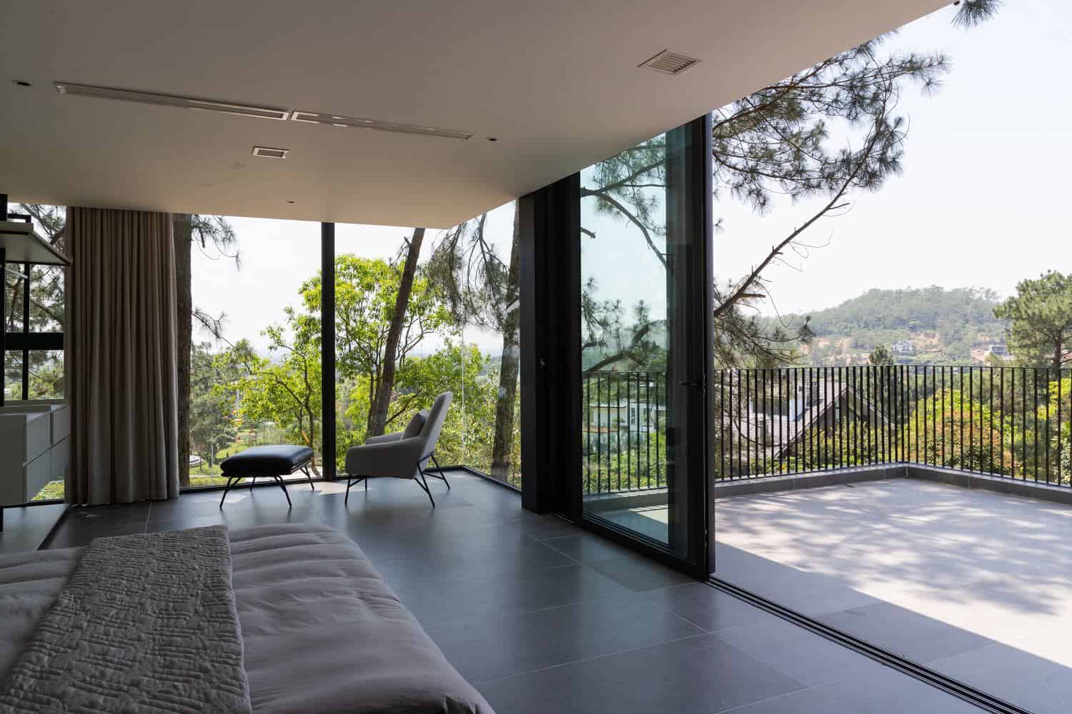 Tam Dao Retreat House by Idee architects master bedroom with access to large terrace in Tam Dao, Vietnam