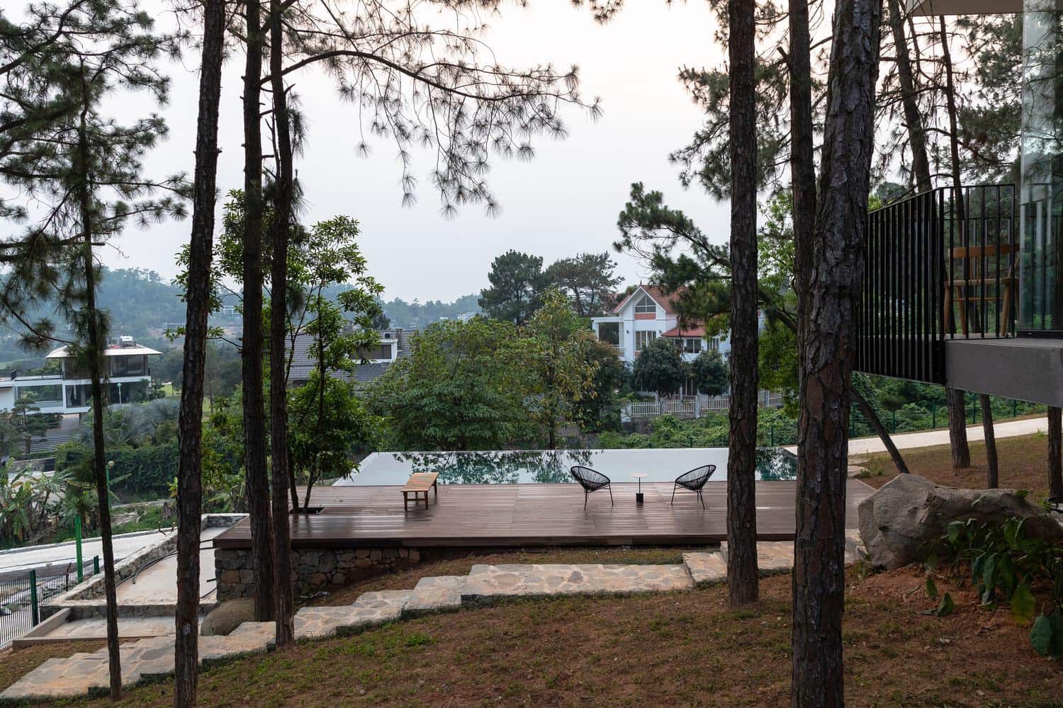 Tam Dao Retreat House by Idee architects pool deck with forest view in Tam Dao, Vietnam
