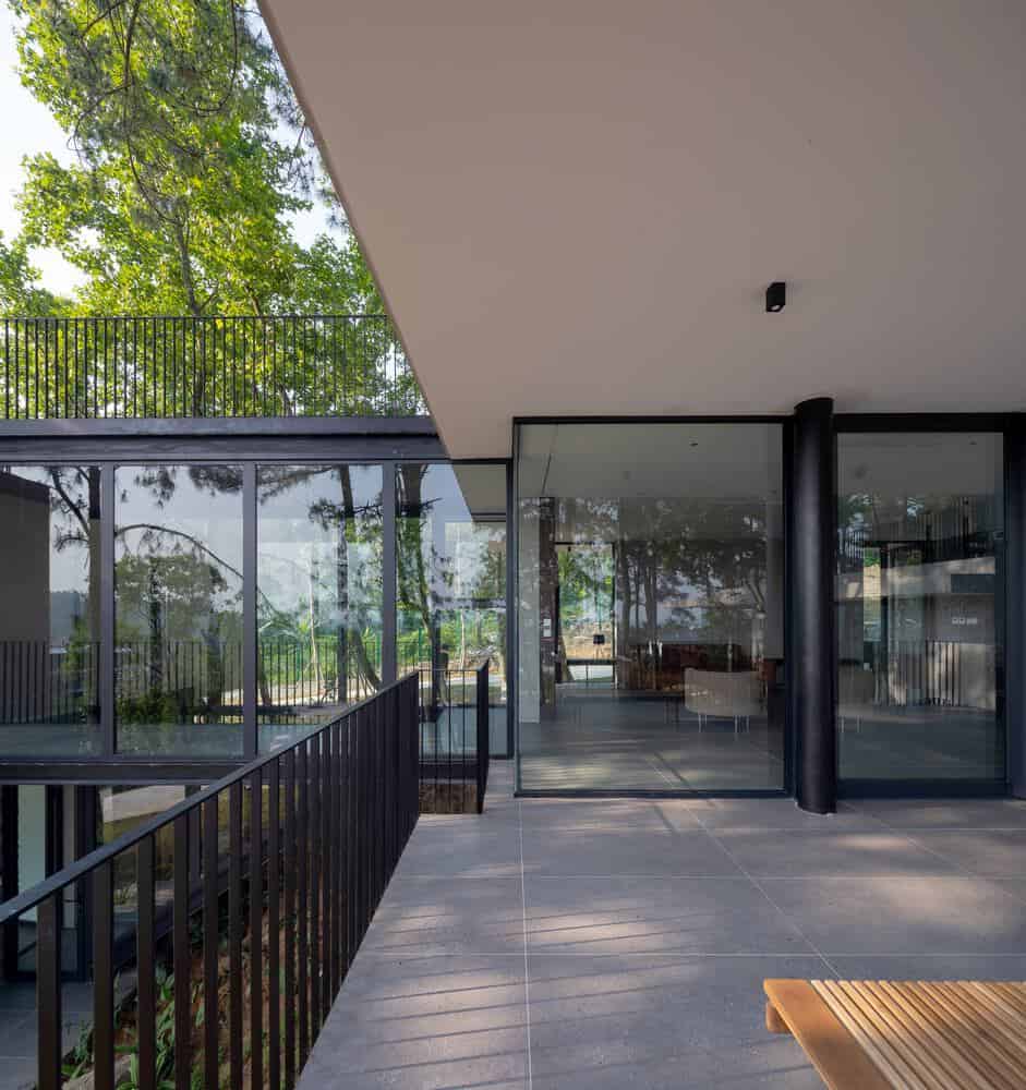 Tam Dao Retreat House by Idee architects terrace bridge connecting glass volumes in Tam Dao, Vietnam