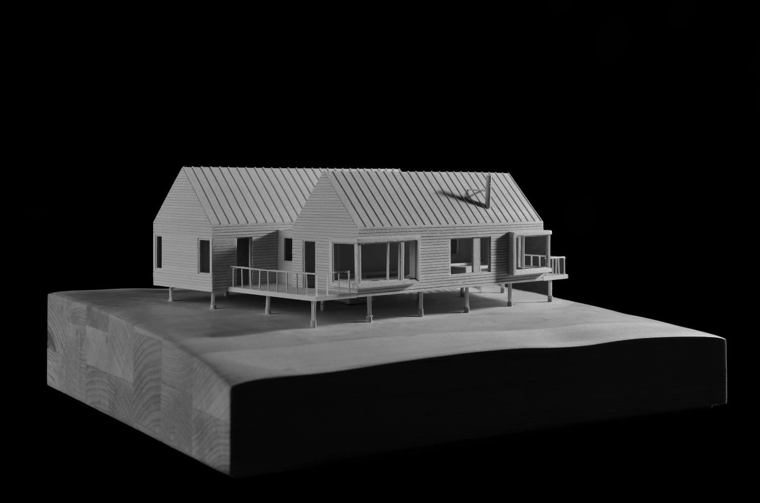 Angled view of the architectural model of Tide Bound House by Peter Braithwaite Studio showing the deck, rooflines and stilted structure