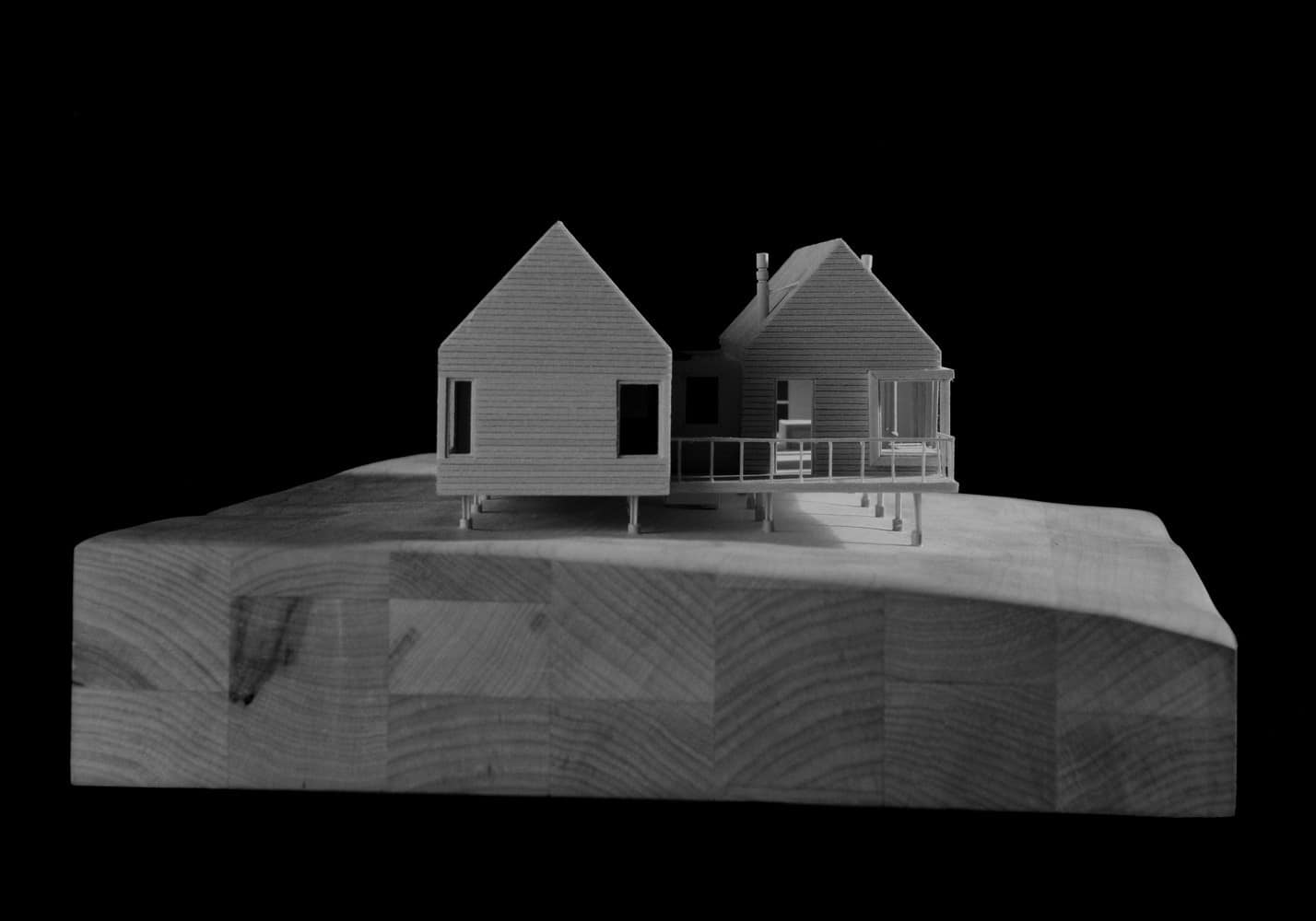 Modern architectural house model on wooden base showcasing innovative design and craftsmanship, perfect for architecture and design enthusiasts.