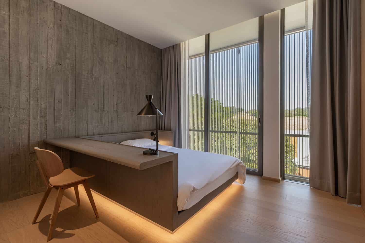 Bedroom at W House II by IDIN Architects with full height screened windows in Thailand