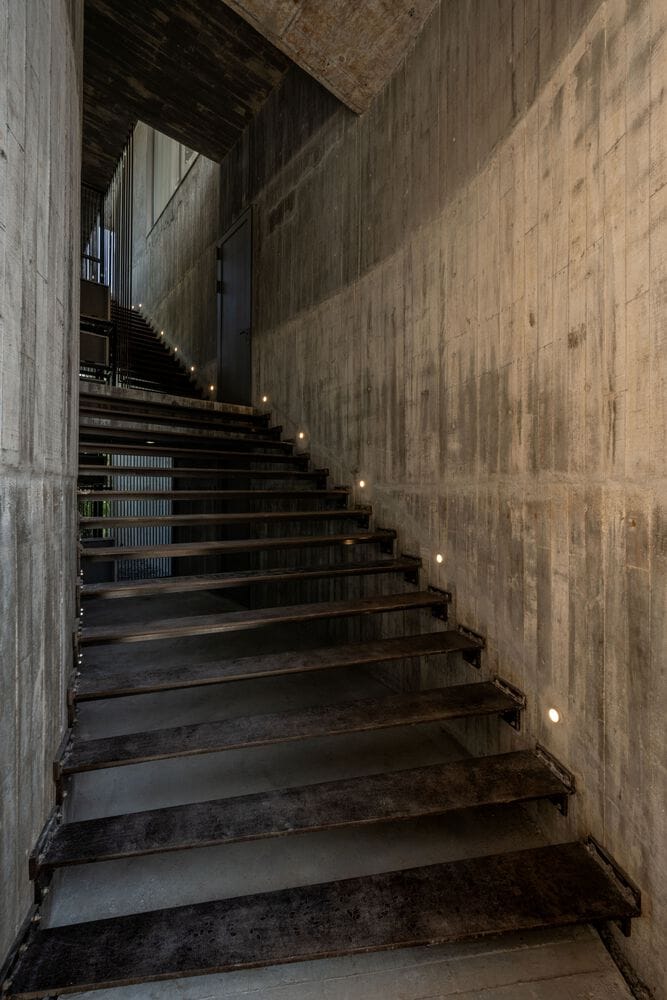 Concrete stair corridor inside W House II by IDIN Architects in Thailand