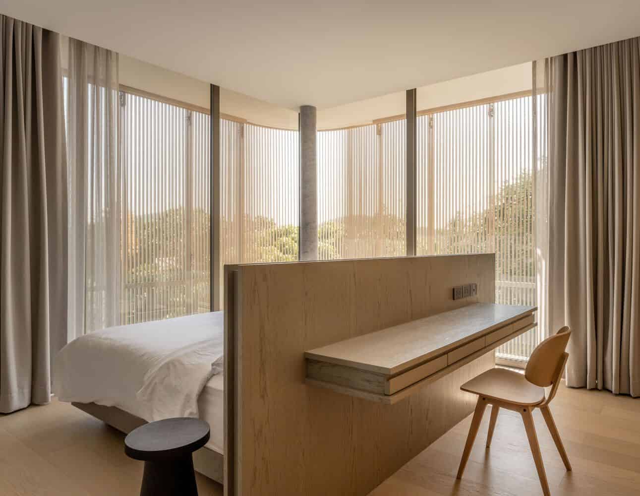 Corner bedroom with curved window screen at W House II by IDIN Architects in Thailand