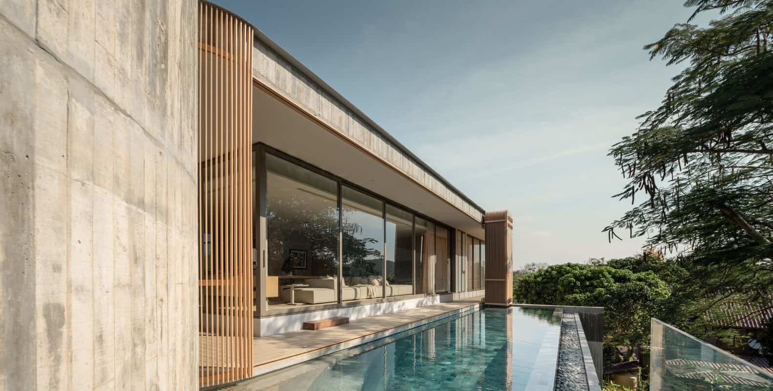 Elevated concrete house with pool facade at W House II by IDIN Architects in Thailand