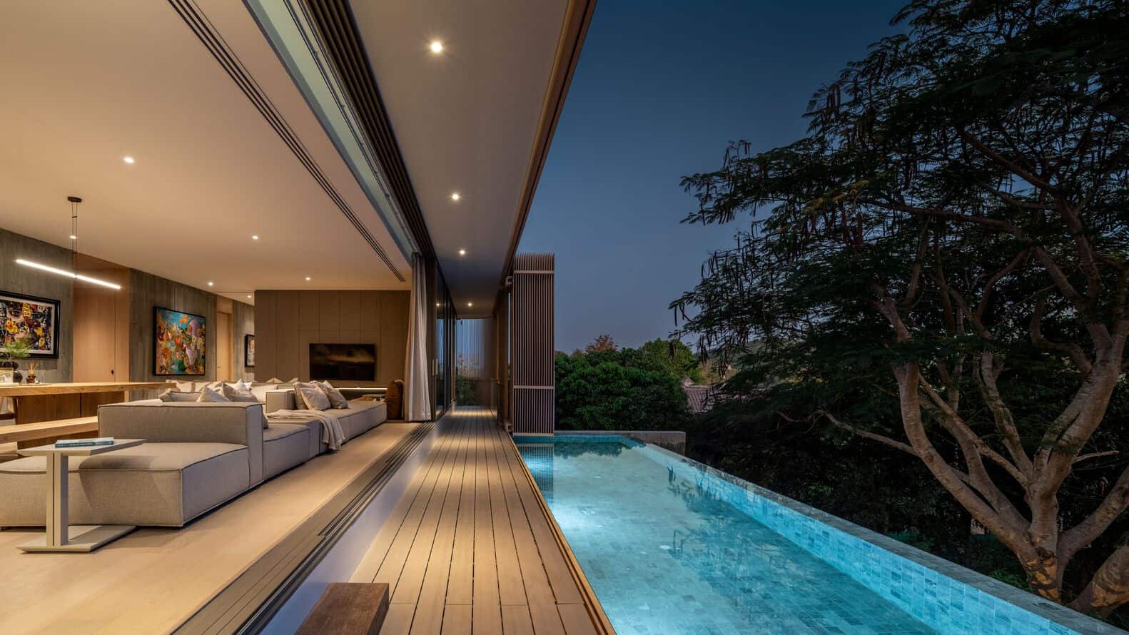 Open-plan living room with infinity pool terrace at W House II by IDIN Architects in Thailand