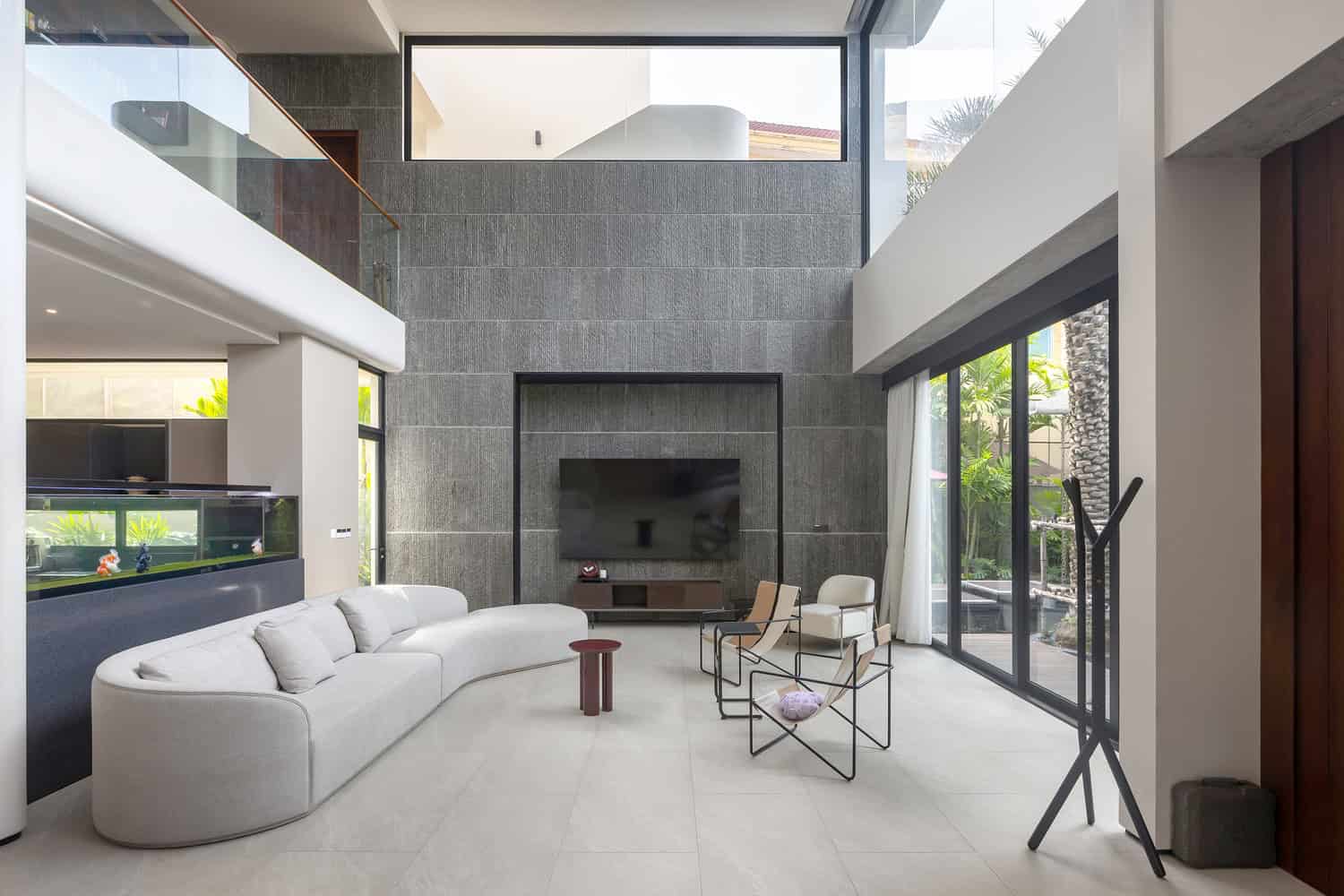 Wat Bo House by UAD Architects dining room with large windows to the garden in Cambodia