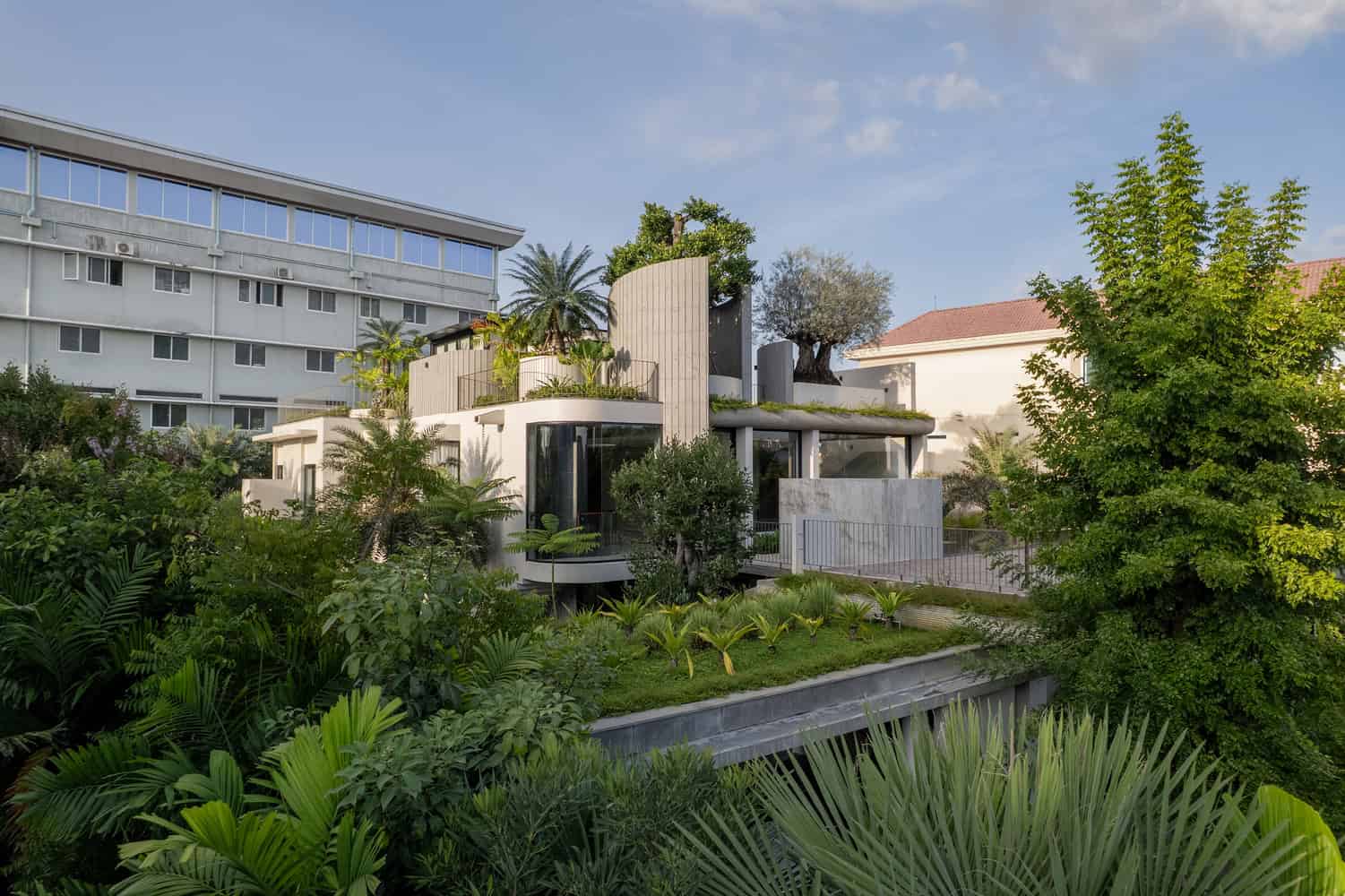 Wat Bo House by UAD Architects overall view with terraced rooftop garden and tropical landscape in Cambodia