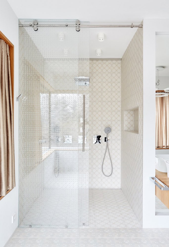 Villa Vista bathroom with glass shower and patterned tiles by Znameni Ctyr Architekti in Prague