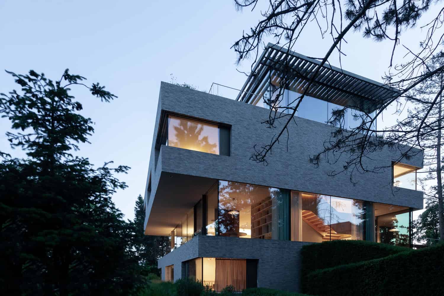 Villa Vista by Znameni Ctyr Architekti, evening garden facade with exterior stair and large windows in Prague