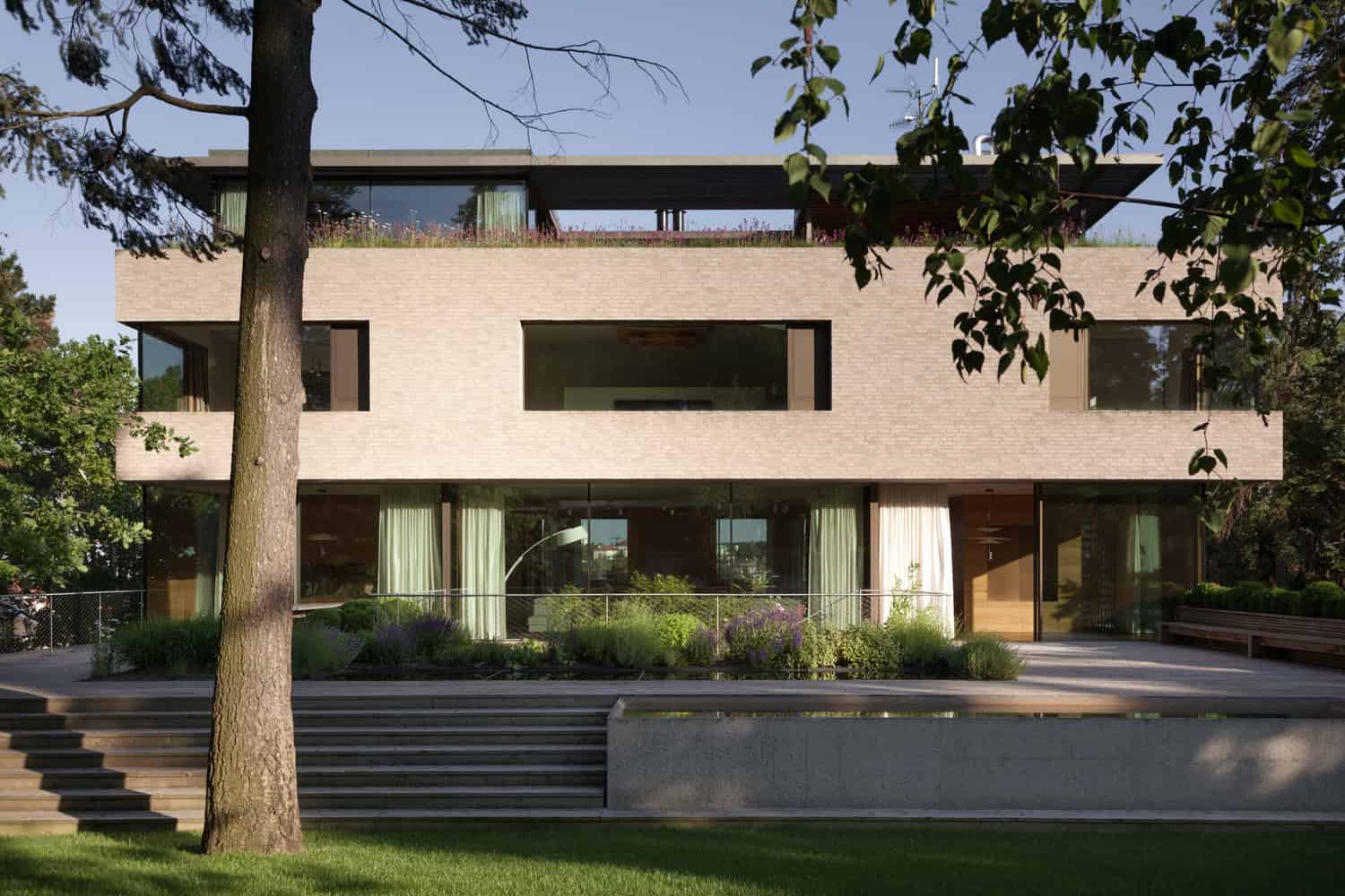 Villa Vista by Znameni Ctyr Architekti, main brick front elevation with garden terrace in Prague