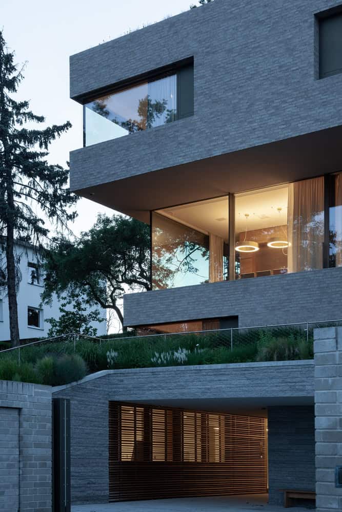 Villa Vista by Znameni Ctyr Architekti, lower level garage entry with horizontal timber slatted screen