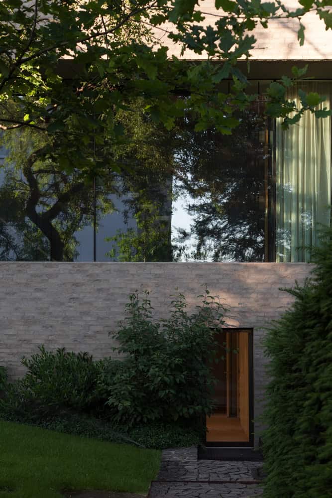 Villa Vista by Znameni Ctyr Architekti, garden path leading to discreet lower level entry