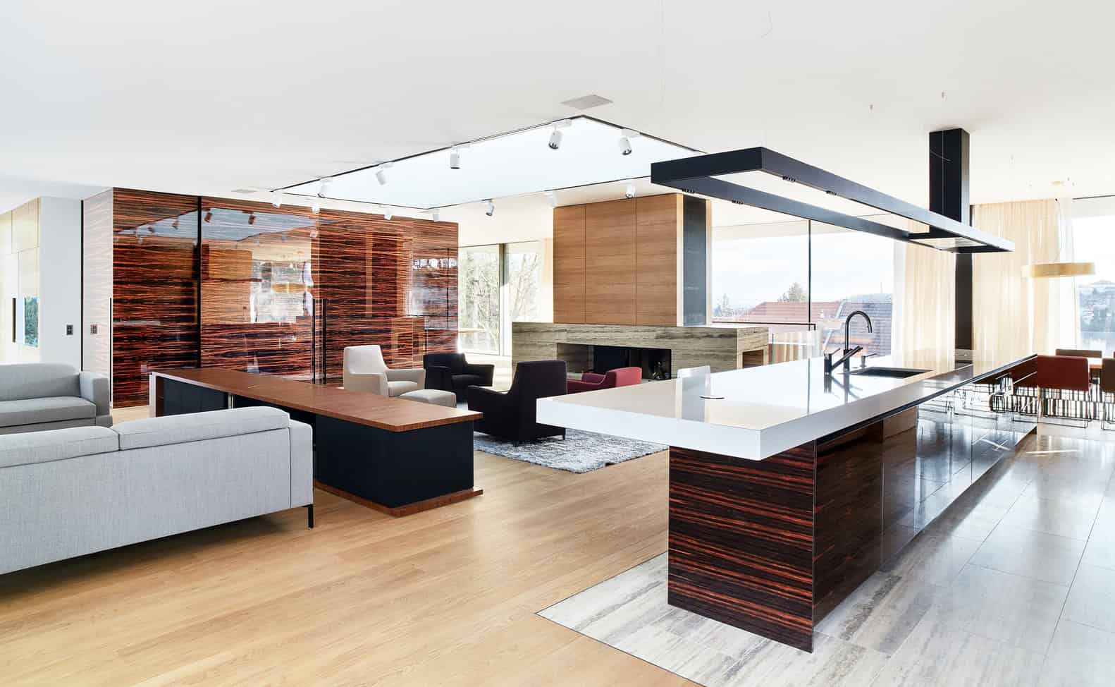 Open-plan living and kitchen at Villa Vista by Znameni Ctyr Architekti in Prague with large island and seating area