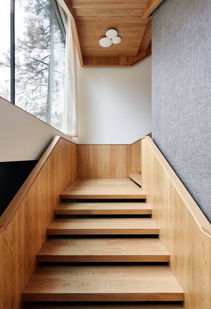 Timber staircase with floating treads at Villa Vista by Znameni Ctyr Architekti in Prague